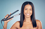 Face, happy woman and hair straightener in studio isolated on a blue background. Portrait, natural beauty and flat iron  of model in healthy salon treatment, hairstyle wellness and hairdresser care