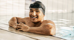 Happy, man and portrait of athlete in swimming pool after training, workout or exercise for wellness, goals or cardio fitness. Swimmer, relax and smile for sports, challenge or success in competition