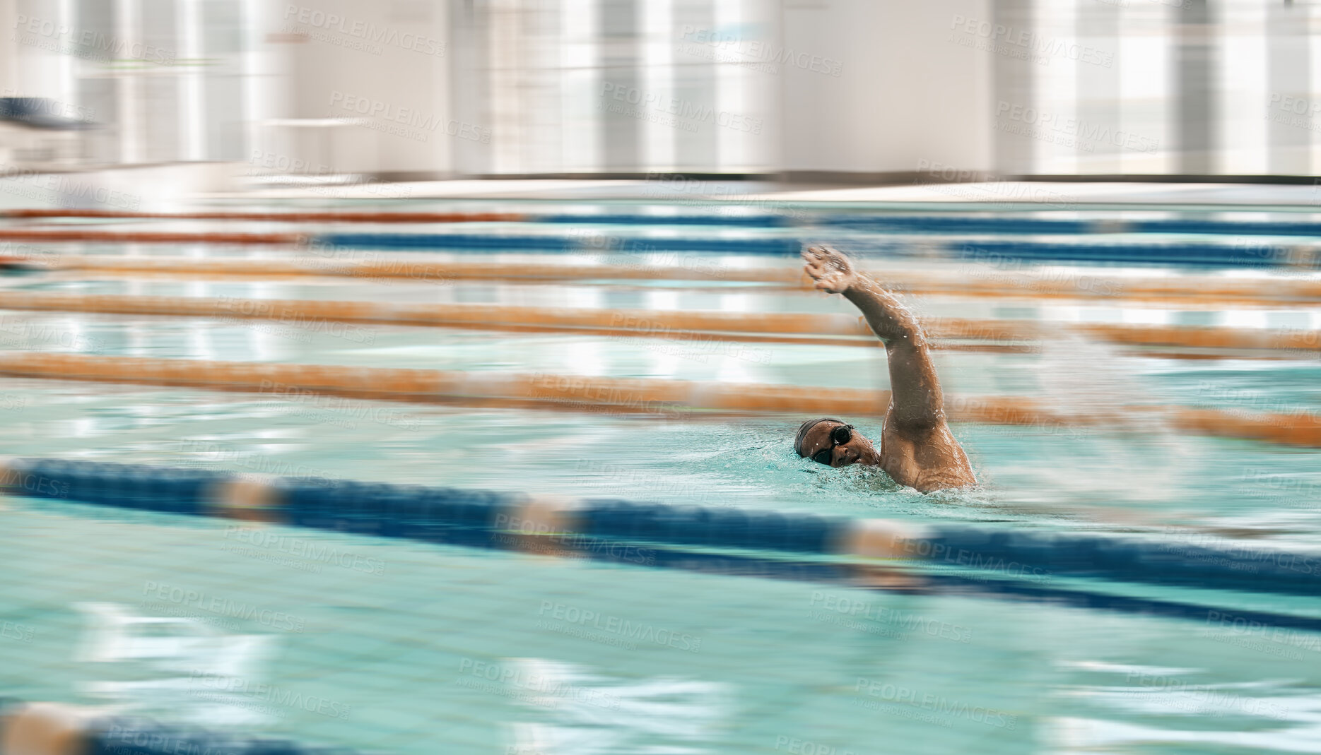 Buy stock photo Fitness, sports and a swimmer in a pool during a race, competition or cardio training at a gym. Exercise, water and workout with an athlete swimming to improve speed, health or freestyle performance