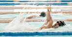 Fitness, water and a swimmer in a pool during a race, competition or cardio training at a gym. Exercise, sports and workout with an athlete swimming to improve speed, health or freestyle performance