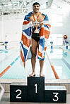 Sports man, trophy and portrait with flag for Great Britain, pride and success by pool, competition and challenge. Swimming guy, champion athlete and winner with celebration, goals and podium for UK