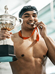 Sports medal, swimming trophy and man portrait with competition success, achievement goal and winning race. Winner, athlete and swimmer with prize, pride and champion bite award at challenge event   