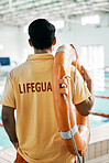 Swimming pool lifeguard, back and person with lifebuoy safety equipment and watch for rescue support, help or service. Surveillance, attention and expert for emergency assistance for public danger