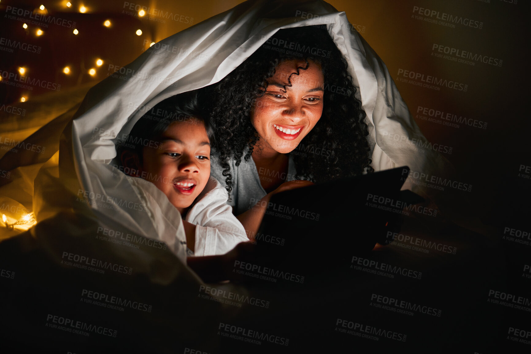 Buy stock photo Night, tablet and mother with child in bedroom with fairy lights for bedtime story, movies and online games. Happy family, reading and mom and kid on digital tech for bonding, love and care in home