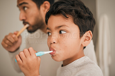 Buy stock photo Face, boy and child brushing teeth with father for hygiene, morning routine or development of healthy oral care at home. Kid, dad and toothbrush for dental cleaning, fresh breath or mouth in bathroom