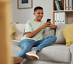 Home, smile and man with a smartphone, relax and typing with connection, mobile user and social media. Person on a couch, lounge or guy with a cellphone, meme and digital app with internet or network