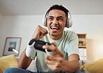 Headphones, couch and man playing video game online with controller winning virtual challenge and excited in celebration. Internet, user experience and person or gamer streaming sports games