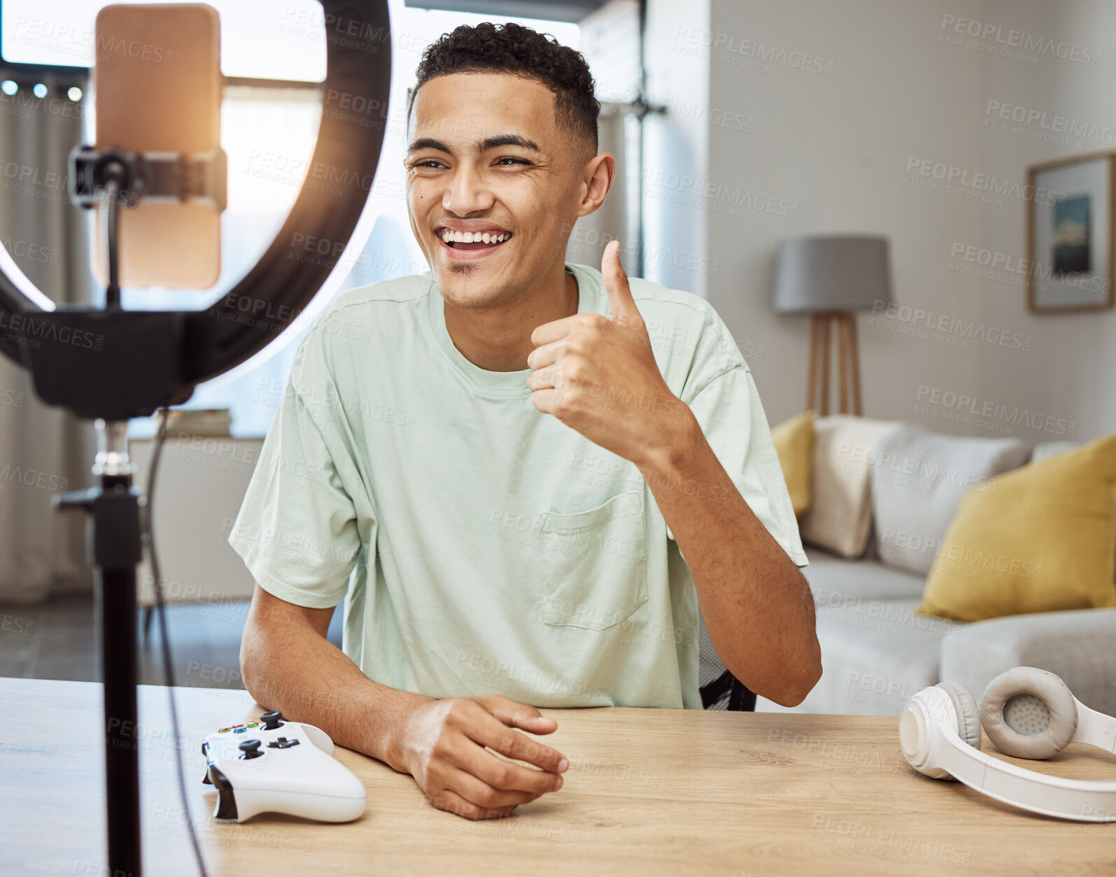 Buy stock photo Man, ring light and thumbs up with social media, influencer and online gamer with streaming and support for video games. Agreement, tech review and young streamer, content creation and gaming promo