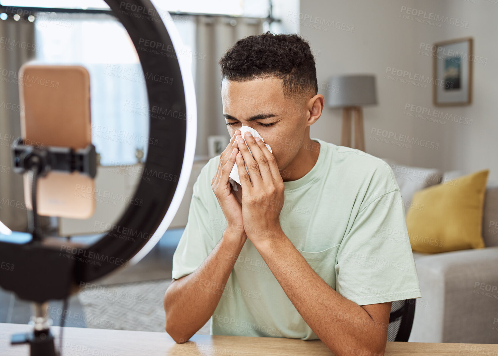 Buy stock photo Sick, live streaming and man with flu, fever and blowing nose or tired of social media and sad online in home. Medical, tissue and frustrated person or influencer on internet, web or blog with sinus