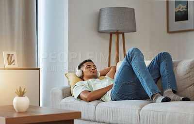 Buy stock photo Man on sofa with headphones, relax and sleep in living room with chill sound, streaming or podcast meditation. Zen, music and person on couch with earphones, peace and calm audio for wellness in home