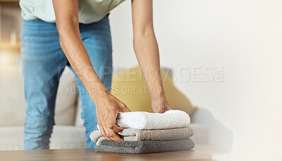 Buy stock photo Towel, worker hands and living room with cleaning service in a home with fabric, cloth and material for washing. Laundry pile, person and cleaner with house maintenance, packing and housekeeping