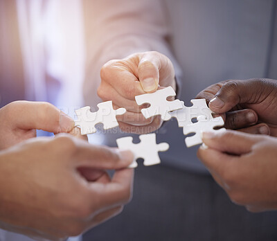 Buy stock photo Business people, hands and teamwork with puzzle collaboration for problem solving, growth and development. Meeting, diversity and coworking jigsaw in team building huddle, men and women with solution