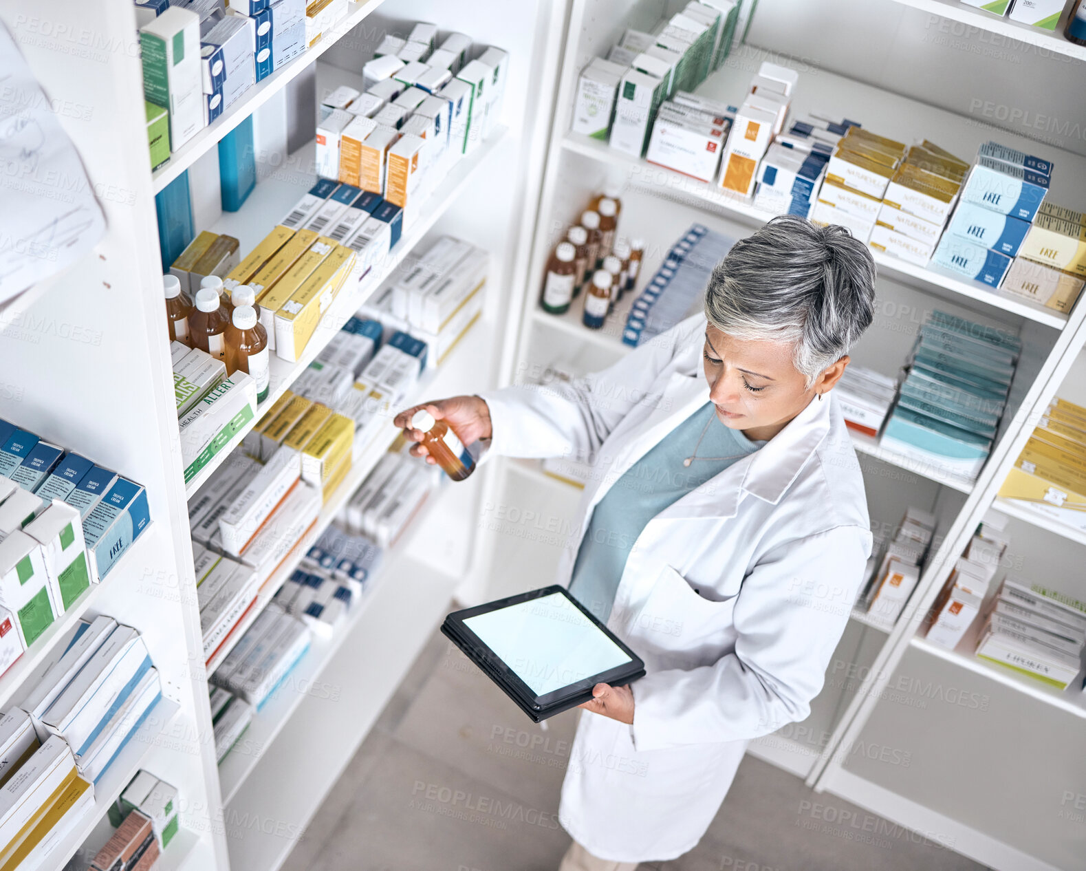 Buy stock photo Medicine, tablet screen and pharmacy woman reading product, bottle or medical stock. Mockup space, top view and mature pharmacist check clinic database for supplements, healthcare or antibiotic info