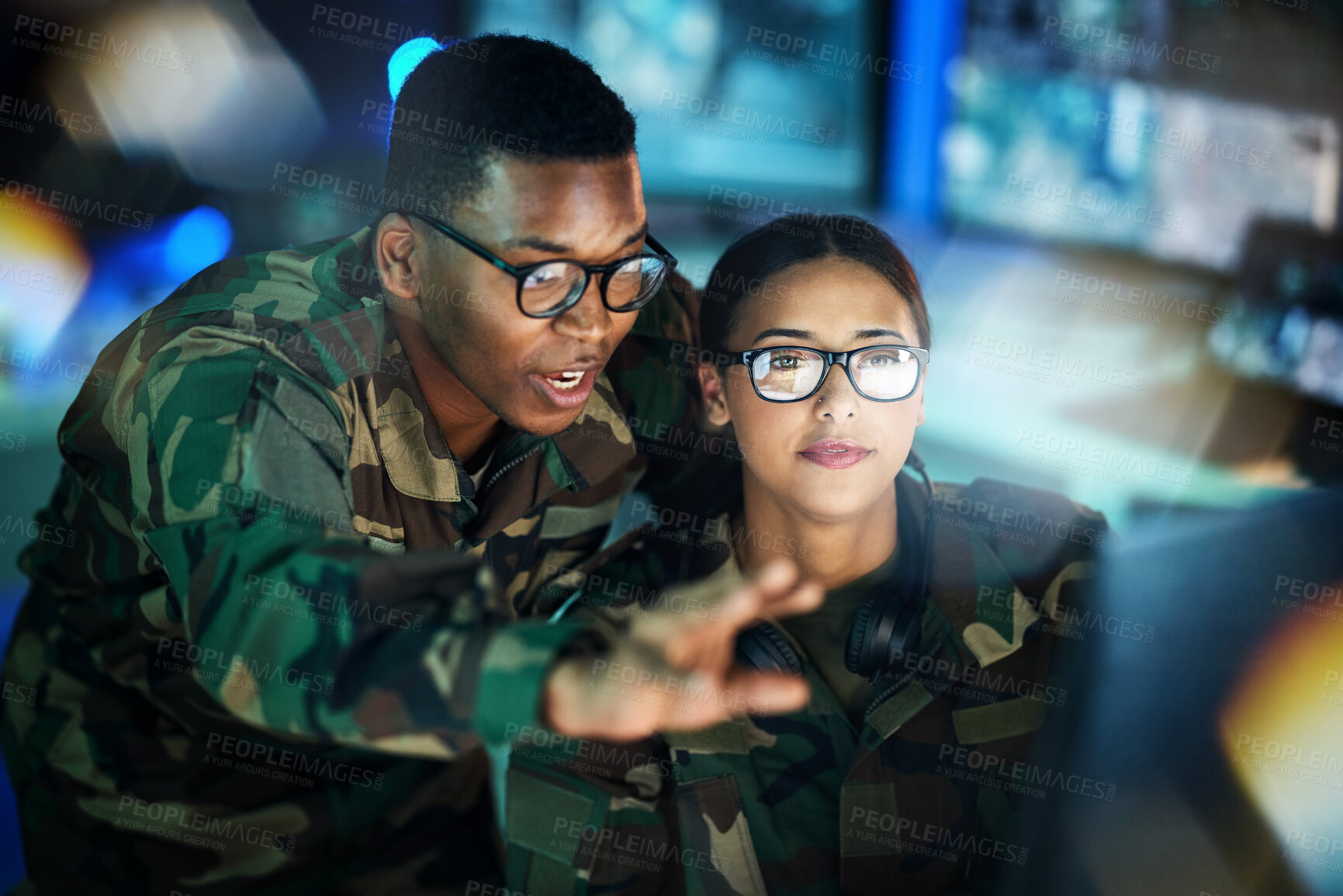 Buy stock photo Night surveillance, army and people with a computer for communication, planning strategy or teamwork. Cyber security, data center and a black man talking to a woman about monitor in a military room