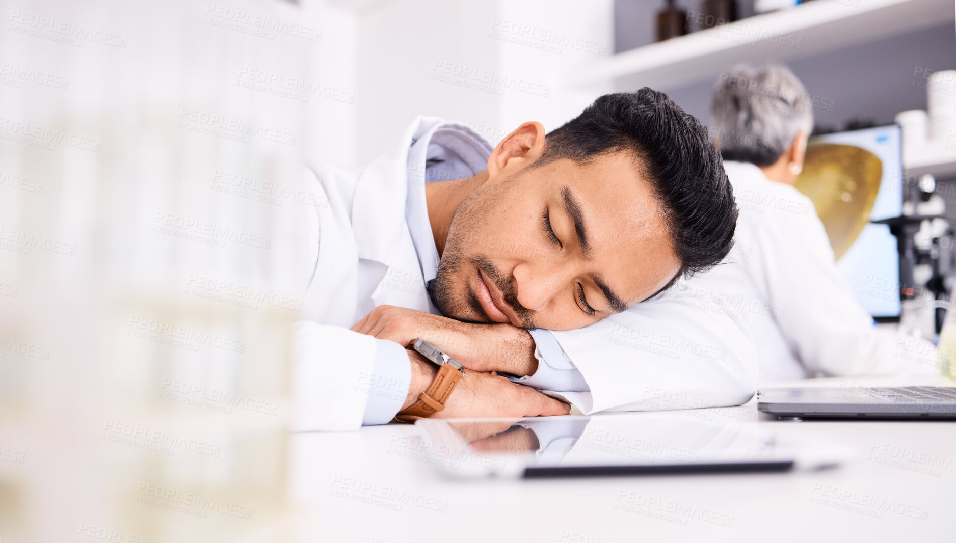 Buy stock photo Asian man, scientist and sleeping on desk in laboratory, burnout or overworked in mental health. Tired male person, medical or healthcare worker asleep in lab rest, dreaming or fatigue at workplace