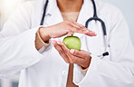 Hands, apple and doctor, health and diet with nutritionist person, healthy food closeup and lose weight. Dietician, healthcare and wellness, green fruit and clean eating with vegan, organic and fiber