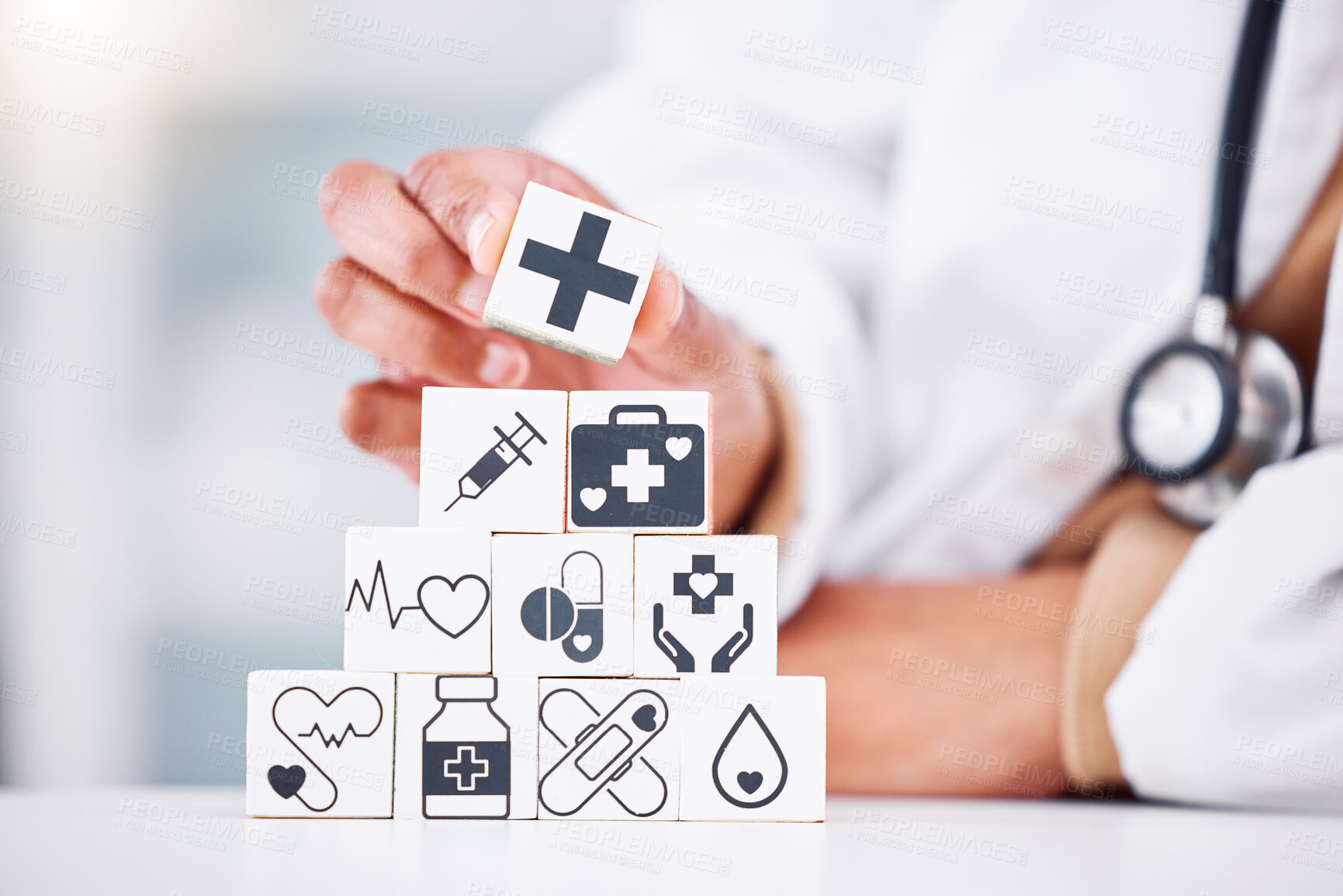 Buy stock photo Hands, medical and a building blocks in a hospital with a doctor closeup for health insurance. Healthcare, icon and symbol with a medicine professional and tower in clinic for cardiology or treatment