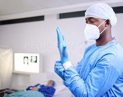 Buy stock photo Doctor, man and surgery, put glove on hand and start operation with face mask, PPE and healthcare at hospital. Surgeon ready for treatment, health and medical professional with patient for wellness