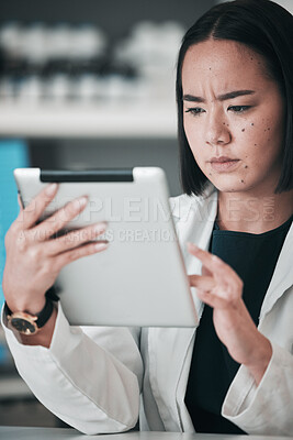 Buy stock photo Tablet, pharmacy and confused Asian woman in laboratory for website, wellness app or telehealth. Healthcare, pharmaceutical and person on digital tech online for medical service, medicine or research