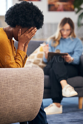 Buy stock photo Mental health, stress and psychology with a black woman in therapy, talking to a professional. Anxiety, depression or support with a young patient in session with a psychologist for grief counseling 