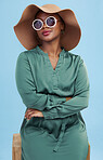 Fashion, sunglasses and portrait of black woman with cool style for summer isolated in a studio blue background. African, hat and young person travel with clothes for glamour  or luxury accessories