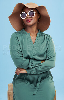 Buy stock photo Fashion, sunglasses and portrait of black woman with cool style for summer isolated in a studio blue background. African, hat and young person travel with clothes for glamour  or luxury accessories