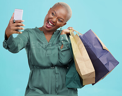 Buy stock photo Shopping bag, studio selfie and happy black woman excited for discount promotion, sales and pose for memory photo. Photography, gift and African customer post picture to online app on blue background