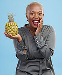 Portrait, wow and black woman pineapple in studio for detox, lose weight or diet nutrition on blue background. Fruit, face and African lady nutritionist show vegan, lifestyle or organic diet choice