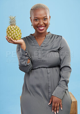 Buy stock photo African woman, pineapple and studio portrait for choice, health and nutrition by blue background. Girl, fruit and happy with decision for diet, eating and vegan food for digestion, vitamins or fiber