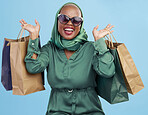 Shopping bag, studio and black woman excited for fashion spree, mall store sales or boutique deal, giveaway or shop offer. Retail therapy gift, choice and wealthy African customer on blue background