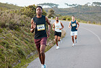 People, fitness and running on road in marathon, sports or outdoor race together in nature. Group of athletic runners on street in cardio workout, training or exercise for competition or triathlon