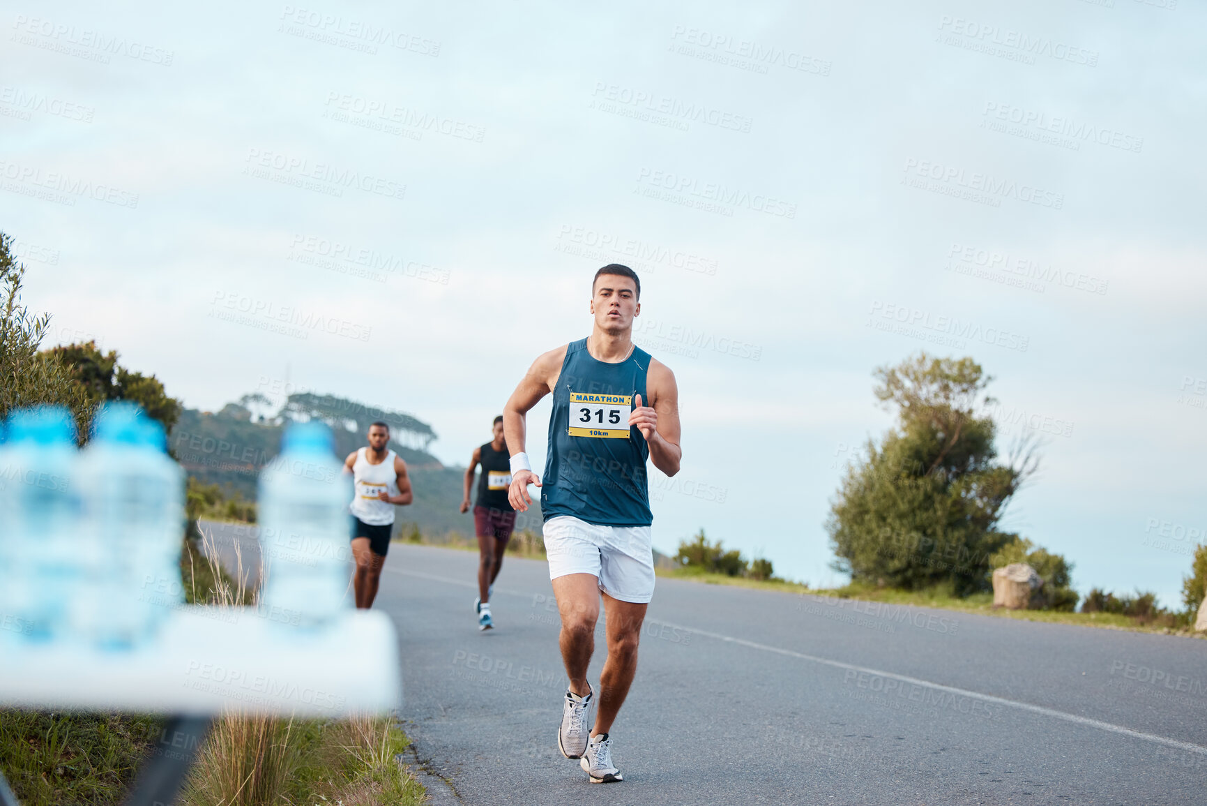 Buy stock photo Man, fitness or running on road in marathon, healthy challenge or outdoor sports race performance. Water bottle, athlete or runner on street in workout, training or exercise for triathlon competition