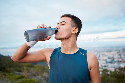 Buy stock photo Man, fitness and drinking water in nature, workout or outdoor exercise on break, rest or recovery. Thirsty male person, sports drink or mineral for sustainability after running, cardio or training