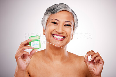 Buy stock photo Senior woman, floss and studio portrait for transformation, beauty and healthy mouth by white background. Mature female model, teeth whitening and string for dental self care, cleaning and smile