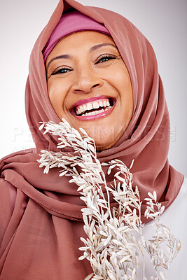 Buy stock photo Happy muslim woman, portrait and face with hijab, plant or fashion against a studio background. Islam, female person and scarf with smile in happiness for religion, stylish clothing or natural beauty