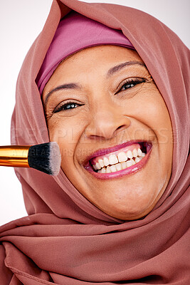 Buy stock photo Cosmetic brush, portrait and muslim woman in studio for makeup, natural and face routine. Smile, self care and happy mature islamic female model with cosmetology tool for facial glamour treatment.