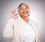 Okay sign, studio and portrait of business woman for success, approval and agreement. Success, corporate and face of happy mature person with hand gesture for like, yes and emoji on gray background