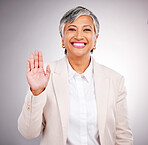 Portrait, senior woman and hand for a pledge, justice or a wave on a studio background. Happy, face and a mature employee or manager with a gesture for hello, pride or patriotic with respect