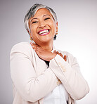 Portrait, happy and a mature business woman laughing in studio on a gray background for success or growth. Comic, smile and face frame with a corporate professional looking confident in a suit