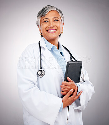 Buy stock photo Senior, happy woman and portrait of doctor with tablet in healthcare research against a studio background. Mature female person or medical professional smile with technology for health advice or help