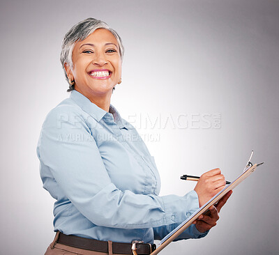 Buy stock photo Portrait, clipboard and mature happy woman writing assessment notes, inspection info or compliance survey. Studio, paperwork and business manager working on report, agenda or list on gray background