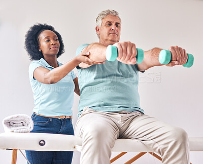 Buy stock photo Old man, exercise and physiotherapy with dumbbell for wellness and muscle training on bed with black woman. Healthcare, physiotherapist and senior with workout for healing help, support and fitness