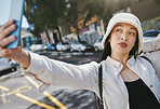 Woman on street with selfie in city, travel holiday memory and social media in streetwear. Influencer, streamer or gen z girl with urban fashion, photography and content creation for vacation blog.