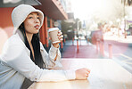 Outdoor, coffee shop and woman relax with drink at cafe, restaurant or table at bistro with gen z in streetwear or urban fashion. City, style and girl in town drinking cappuccino in cup with bokeh