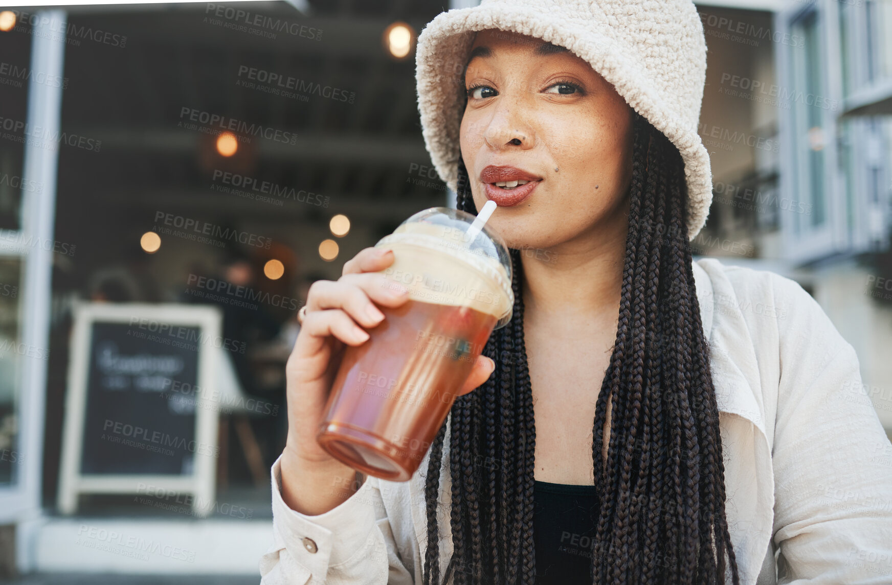 Buy stock photo Woman, smoothie and portrait outdoor at a restaurant and drink from cafe with a smile. Milkshake, coffee shop and gen z fashion of a female person drinking from a straw on break on diner patio