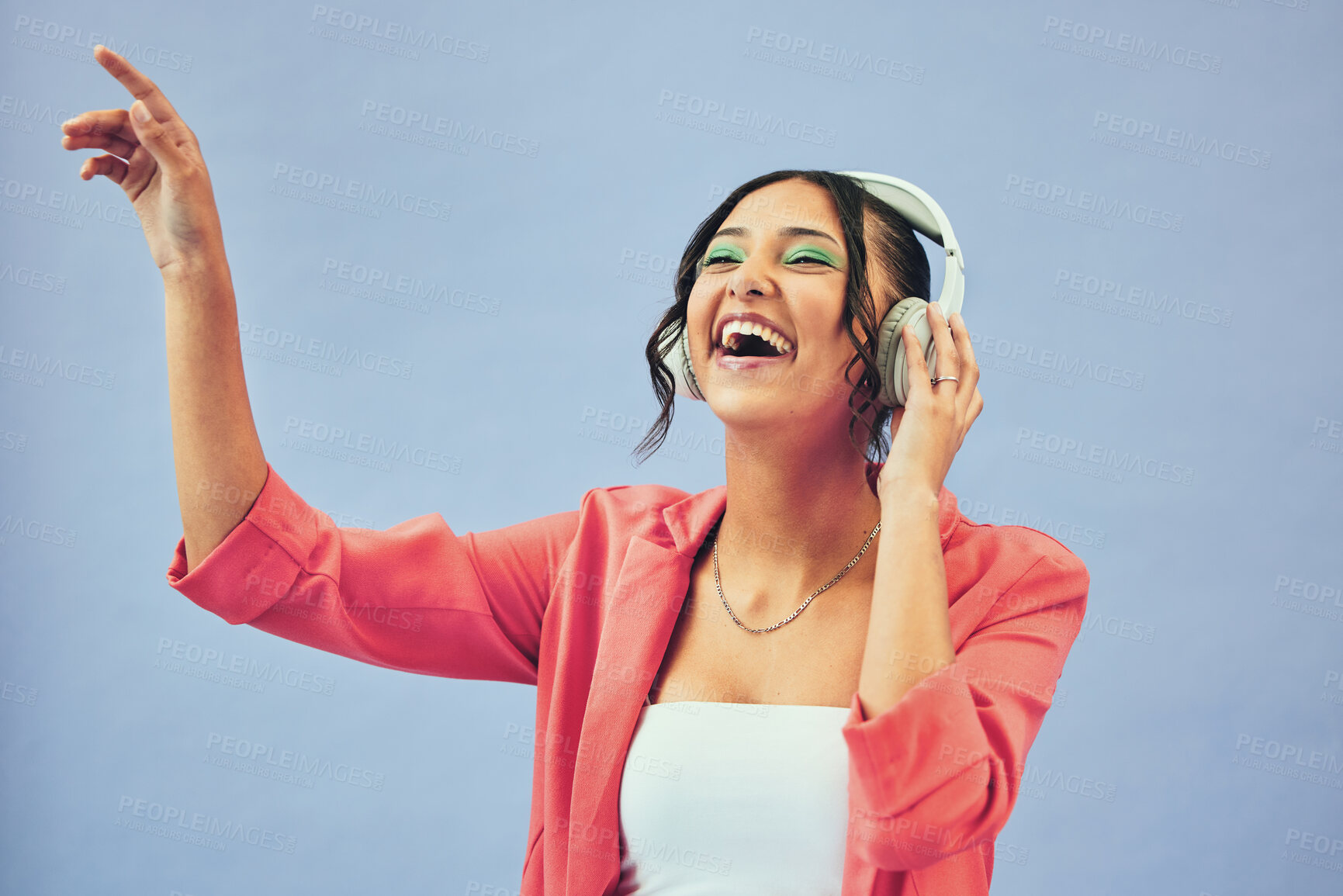 Buy stock photo Fashion, music and happy woman dance in studio with trendy, clothes and feel good audio on blue background. Style, smile and female model with freedom, energy or moving to radio, streaming or podcast