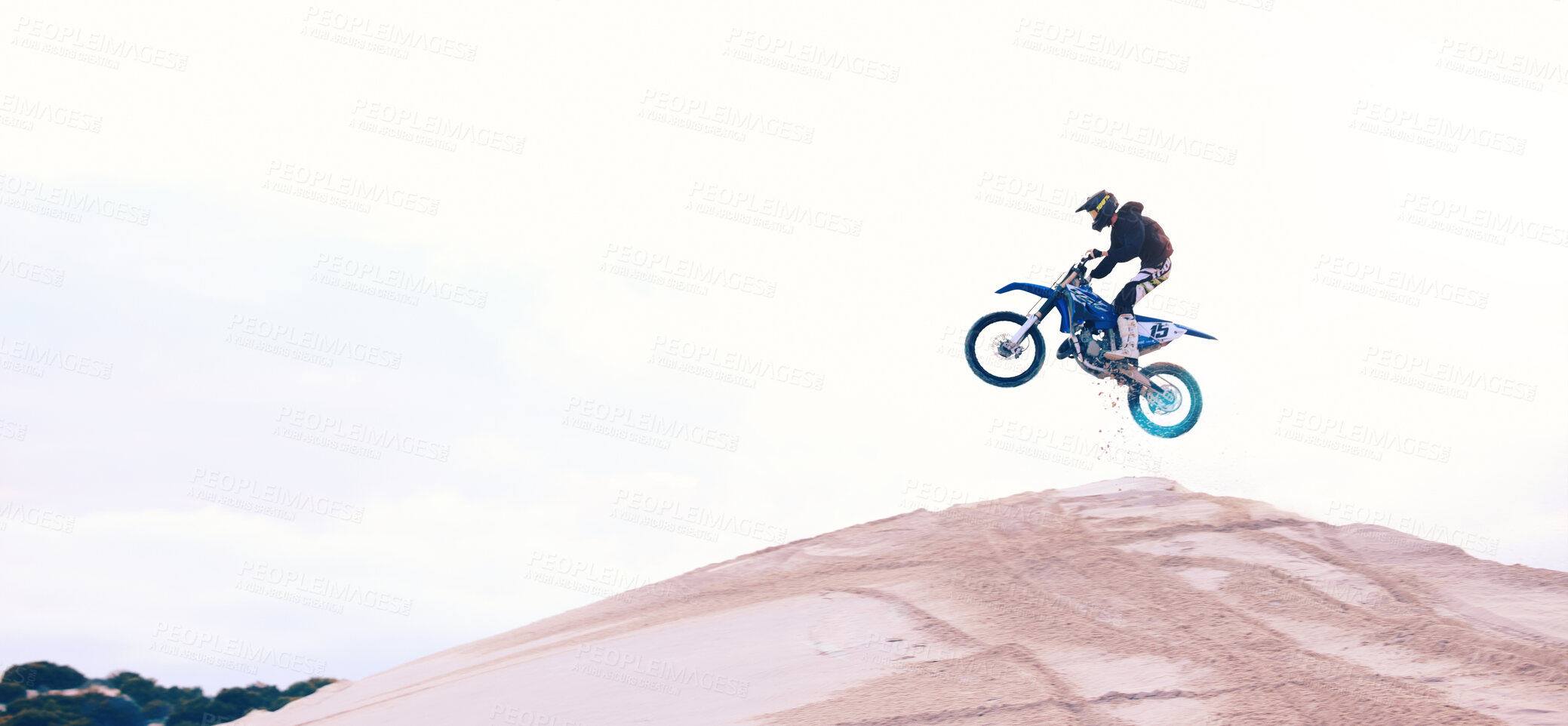 Buy stock photo Sand, jump or athlete driving motorbike for action, adventure or fitness with performance or adrenaline. Speed, air or driver on motorcycle on dunes hill for training, exercise or race challenge