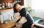 Hug, love and woman with a dog in home kitchen to relax and play with animal. Pet owner, happiness and asian person playing with companion, care and wellness or friendship in cozy apartment
