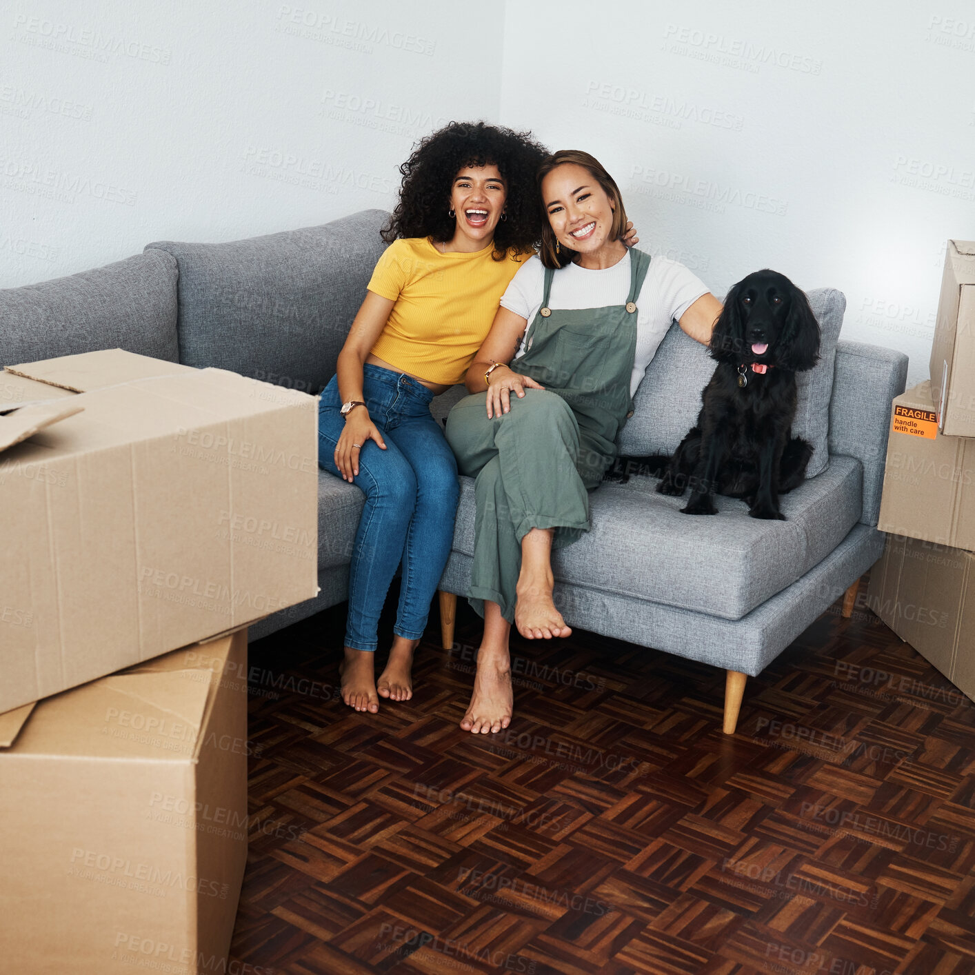 Buy stock photo Dog, lesbian couple and new real estate, portrait and bonding together in living room. Happy gay women with pet in house on sofa, apartment and moving in to property home, laughing and funny animal