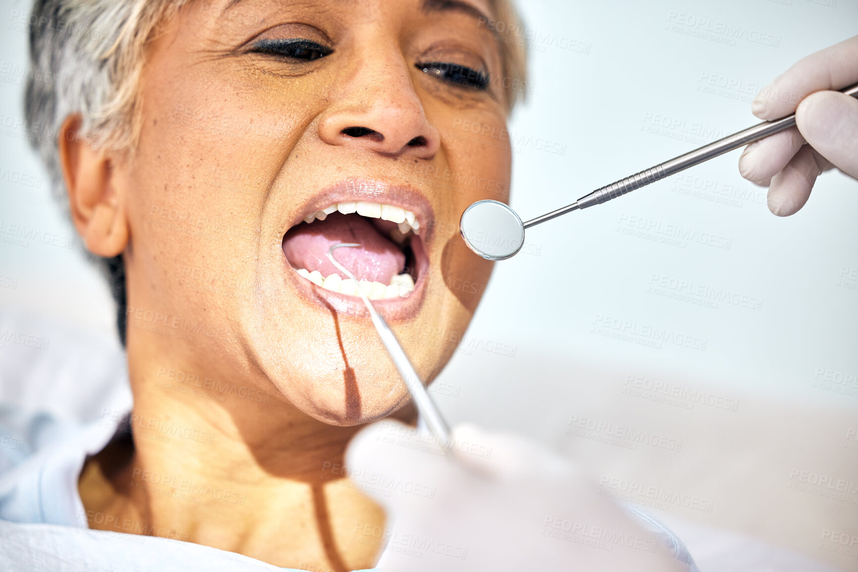 Buy stock photo Senior woman, mouth and dentist check teeth, metal tools and hands with healthcare, toothache and dental surgery. Cleaning, wellness and health with oral care procedure, equipment and help with trust